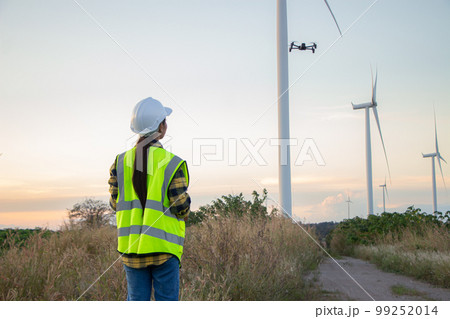 asian female and man Manager Engineer in Safety Helmet Checking With Tablet An Operation Of Solar Panel System At Solar Station in farm. 99252014