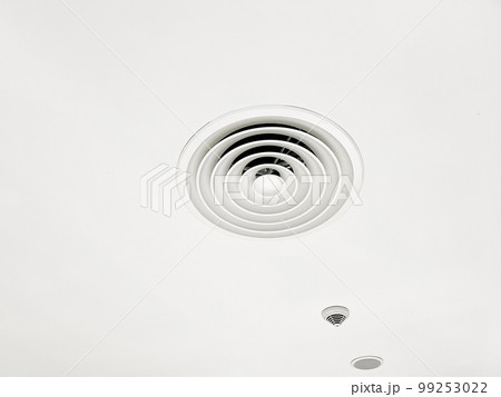 Ceiling mounted cassette type air conditioner and modern lamp light on white ceiling. duct air conditioner for home or office 99253022