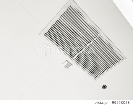 Ceiling mounted cassette type air conditioner and modern lamp light on white ceiling. duct air conditioner for home or office 99253023