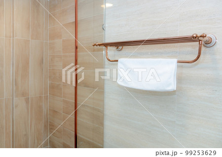 Clean white towel on a hanger in bathroom Clean white towel on a hanger in bathroom 99253629
