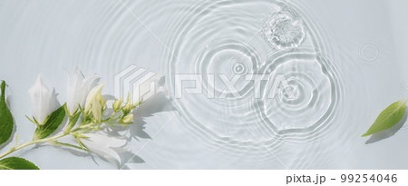 Water background with flowers, drops and circles on the water 99254046