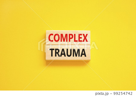 Complex trauma symbol. Concept words Complex trauma on wooden block. Beautiful yellow table yellow background. Business psychology complex trauma concept. Copy space. 99254742