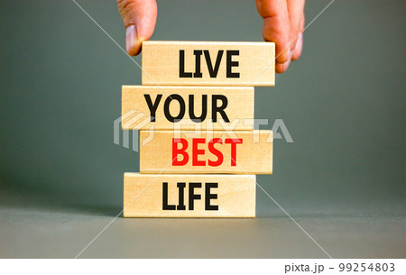 Live your best life symbol. Concept words Live your best life on wooden blocks. Beautiful grey table grey background. Businessman hand. Business live your best life concept. Copy space. Live your best life symbol. Concept words Live your best life on wooden blocks. Beautiful grey table grey background. Businessman hand. Business live your best life concept. Copy space. 99254803