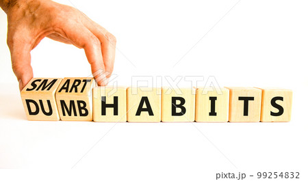 Smart or dumb habits symbol. Concept word Smart habits and Dumb habits on wooden cubes. Beautiful white table white background. Businessman hand. Business smart or dumb habits concept. Copy space. Smart or dumb habits symbol. Concept word Smart habits and Dumb habits on wooden cubes. Beautiful white table white background. Businessman hand. Business smart or dumb habits concept. Copy space. 99254832