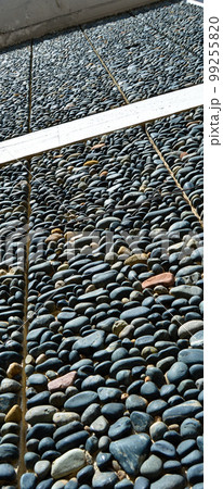 Wall texture decorated with blue pebbles, pebbles glued to the wall 99255820