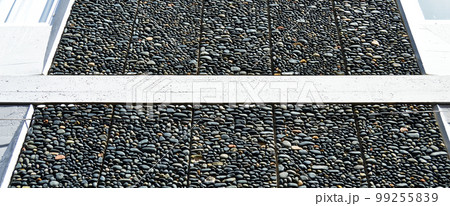 Wall texture decorated with blue pebbles, pebbles glued to the wall 99255839