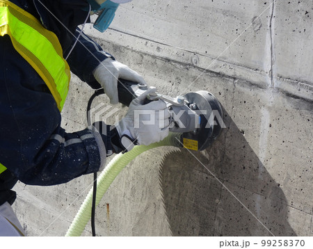集塵サンダーでコンクリート表面の素地調整をしている様子 99258370