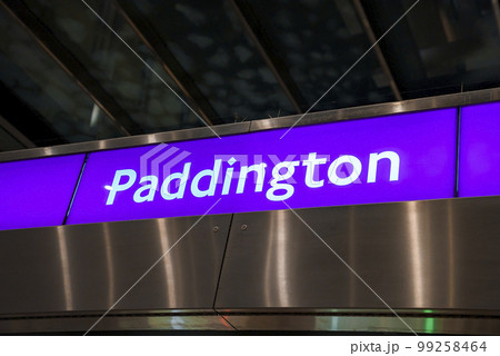 Low angle view of Paddington text on purple signboard in modern underground subway station at London 99258464