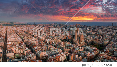 Aerial view of Barcelona City Skyline and Sagrada Familia Cathedral at sunset. Eixample residential famous urban grid. Cityscape with typical urban octagon blocks Aerial view of Barcelona City Skyline and Sagrada Familia Cathedral at sunset. Eixample residential famous urban grid. Cityscape with typical urban octagon blocks 99258501
