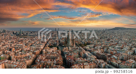 Aerial view of Barcelona City Skyline and Sagrada Familia Cathedral at sunset. Eixample residential famous urban grid. Cityscape with typical urban octagon blocks 99258516
