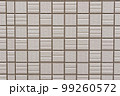 ベージュ色のタイルの壁 99260572