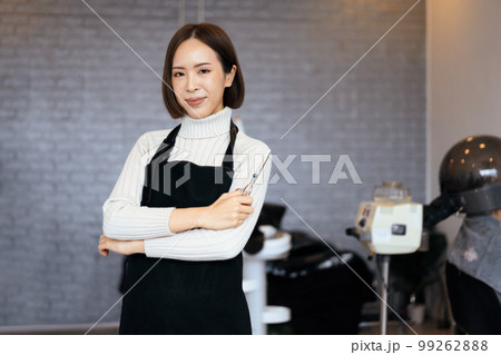 Portrait of a young asian female hairdresser holding qualified haircut tools. Portrait of a young asian female hairdresser holding qualified haircut tools. 99262888
