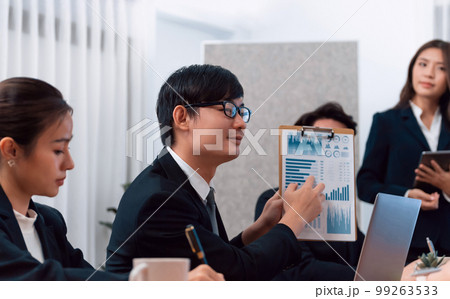 Business team of financial data analysis meeting report paper in harmony office. 99263533