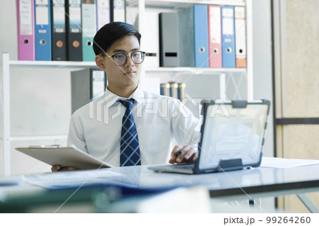 Businessman is analyzing online marketing on laptop computer 99264260