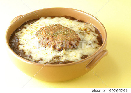 たっぷりのチーズとハンバーグが乗っている焼きカレー 99266291