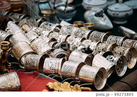 Glass Holders Or Podstakannik From Ussr In A Row At Flea Market. The Podstakannik, Or Tea Glass Holder, Is A Holder With A Handle, Most Commonly Made Of Metal That Holds A Drinking Glass stakan Glass Holders Or Podstakannik From Ussr In A Row At Flea Market. The Podstakannik, Or Tea Glass Holder, Is A Holder With A Handle, Most Commonly Made Of Metal That Holds A Drinking Glass stakan 99273805