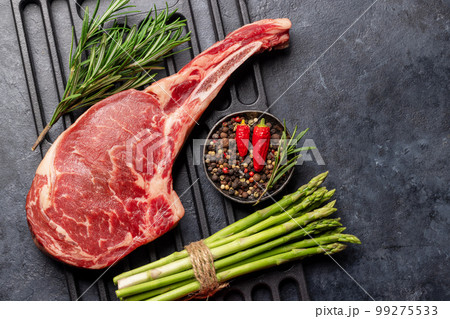Raw Tomahawk beef steak and spices Raw Tomahawk beef steak and spices 99275533