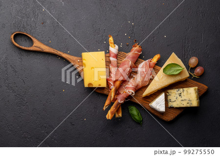Antipasto board with various cheese and snacks Antipasto board with various cheese and snacks 99275550