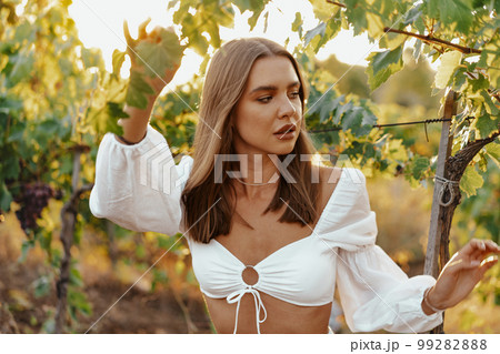Young woman posing in the grape fields. Young woman posing in the grape fields. 99282888
