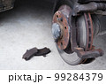 Car repair. Replacing the brake pads of disc brakes. Brake disc close-up. 99284379
