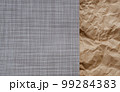 Top view photo of Crumpled craft paper and Beige mat of dry wicker fiber as texture, background. 99284383