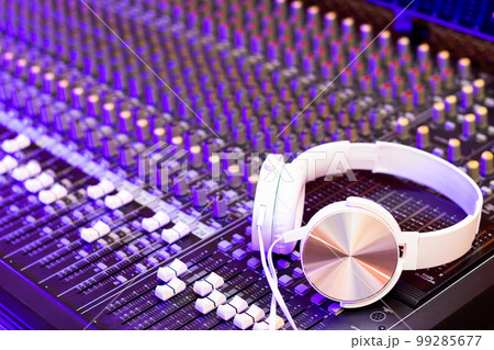white headphone on audio mixing console. music, broadcasting, recording, music production, live concept 99285677
