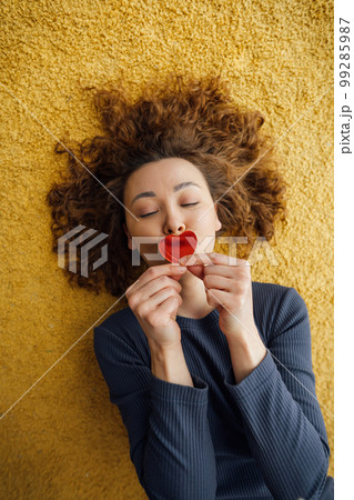 Beautiful woman in love kissing heart shaped card Beautiful woman in love kissing heart shaped card 99285987