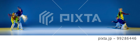 Music in moves. Young expressive contemp dance dancers dancing in neon light. Concept of dance, youth, hobby, dynamics, movement, action, ad. Banner with copy space 99286446