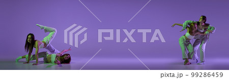 Music in moves. Young expressive contemp dance dancers dancing in neon light. Concept of dance, youth, hobby, dynamics, movement, action, ad. Banner with copy space 99286459