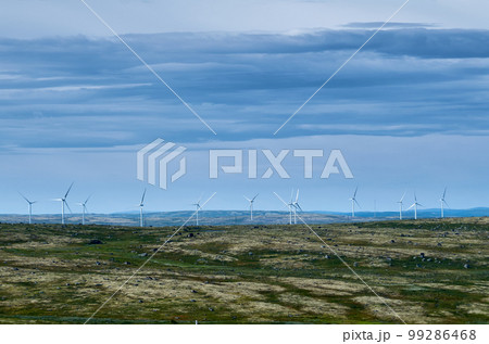 Wind farm in hilly area under cloudy sky Wind farm in hilly area under cloudy sky 99286468