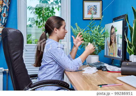 Teenage upset crying girl on online therapy with a psychologist 99286951