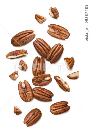 Fresh pecans isolated on white background. Nuts scattered. Top view. Vertical layout. 99287485