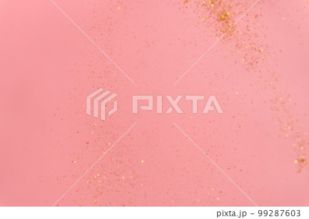 pink abstract background with flying gold sequins pink abstract background with flying gold sequins 99287603