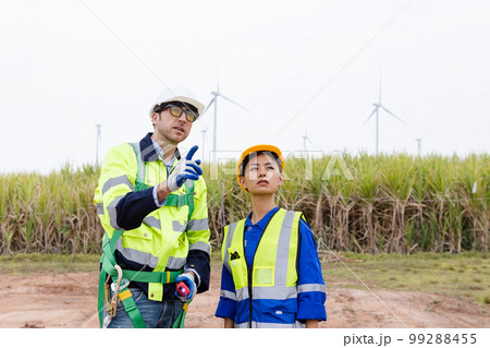 Team engineer of wind turbine worker pointing working about renewable energy 99288455