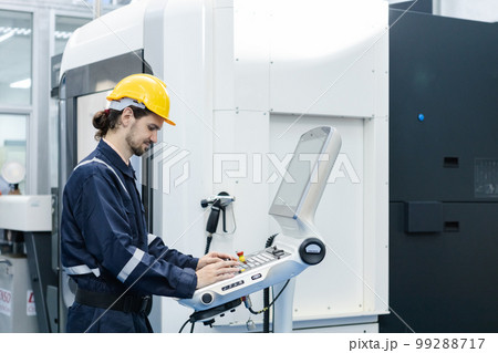 Man engineer using computer controlling cnc machine at workshop. professional male control Man engineer using computer controlling cnc machine at workshop. professional male control 99288717