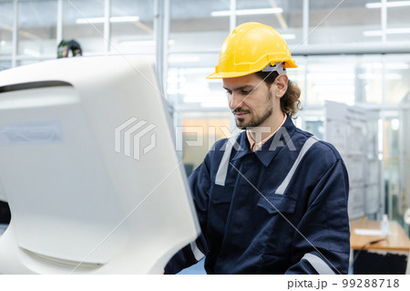 Man engineer using computer controlling cnc machine at workshop. professional male control Man engineer using computer controlling cnc machine at workshop. professional male control 99288718