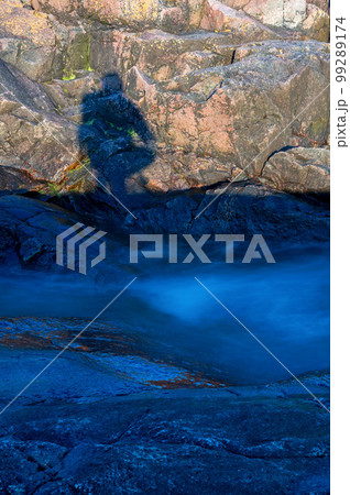 Creeping fog on sea rocks, close-up photo. Creeping fog on sea rocks, close-up photo. 99289174
