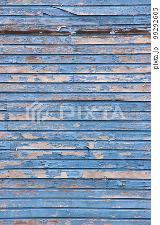 Old barnwood straight on vertical texture with peeling blue paint 99292605