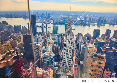 High up in New York City overlooking Manhattan next to glass reflecting window High up in New York City overlooking Manhattan next to glass reflecting window 99292610