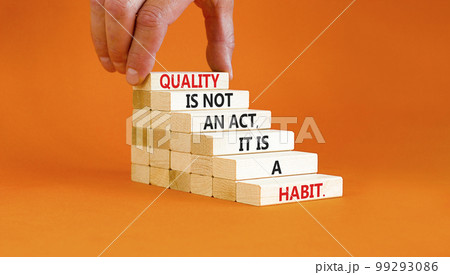 Quality is a habit symbol. Concept words Quality is not an act it is a habit on wooden blocks. Beautiful orange table orange background. Businessman hand. Business quality is habit concept. Copy space Quality is a habit symbol. Concept words Quality is not an act it is a habit on wooden blocks. Beautiful orange table orange background. Businessman hand. Business quality is habit concept. Copy space 99293086
