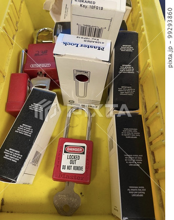 Lock out tag out locks locks in a yellow tote Lock out tag out locks locks in a yellow tote 99293860