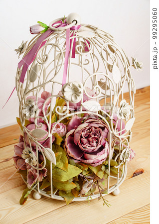 decorative cage with a composition of artificial flowers. 99295060