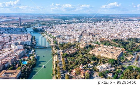 Aerial view of the Spanish city of Seville in the Andalusia region on the river Guadaquivir overlooking the cathedral and Real Alcazar Aerial view of the Spanish city of Seville in the Andalusia region on the river Guadaquivir overlooking the cathedral and Real Alcazar 99295450