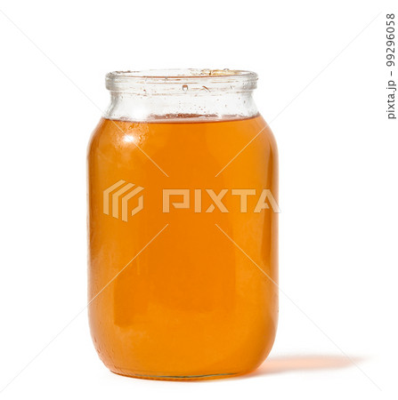 Transparent glass jar with bee honey on a white isolated background Transparent glass jar with bee honey on a white isolated background 99296058