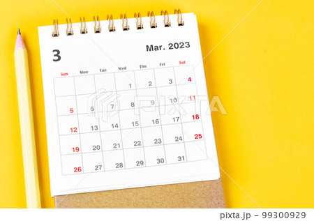The March 2023 Monthly desk calendar for 2023 with pencil on yellow background. 99300929