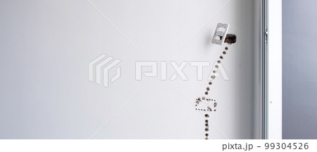 Electrical Wiring under plaster, hidden installation cables for socket to a concrete. Renovation, Repair and development of home and apartment concepts 99304526