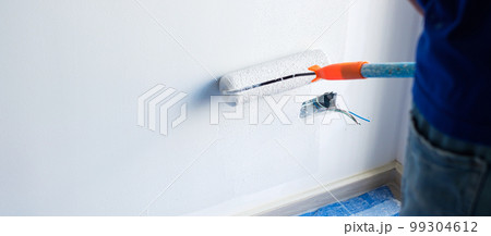 painter man with paint roller brush painting the wall. Renovation, maintenance and development of home or apartment painter man with paint roller brush painting the wall. Renovation, maintenance and development of home or apartment 99304612