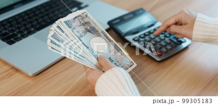 Woman hand counting Japanese Yen banknote with calculator. Thousand Yen money. Japan cash, Tax, Recession Economy, Inflation, Investment, finance, salary and payment concepts 99305183
