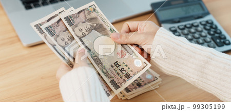 Woman hand counting Japanese Yen banknote with calculator. Thousand Yen money. Japan cash, Tax, Recession Economy, Inflation, Investment, finance, salary and payment concepts Woman hand counting Japanese Yen banknote with calculator. Thousand Yen money. Japan cash, Tax, Recession Economy, Inflation, Investment, finance, salary and payment concepts 99305199