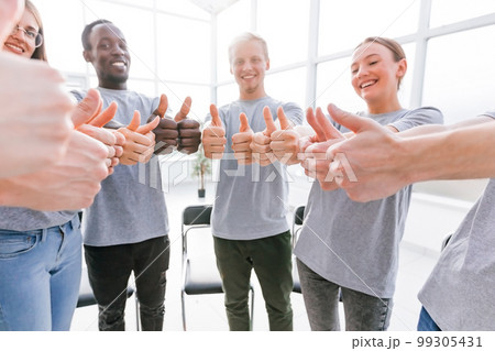 close up. smiling group of young people standing in a circle. close up. smiling group of young people standing in a circle. 99305431